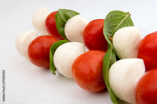 Caprese of mozzarella, tomato cherry and basil, tradition mediterranean snack, on white