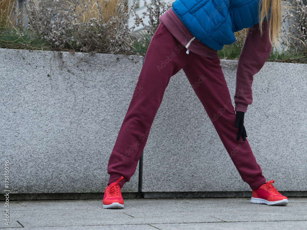 Sporty girl stretching outdoor on city street. Sporty girl stretching outdoor on city street.