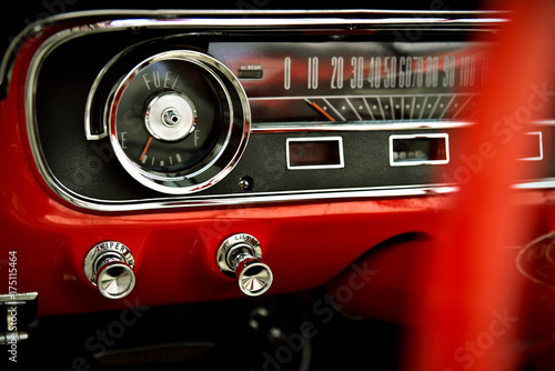 Dashboard of classic red retro car © aboutfoto