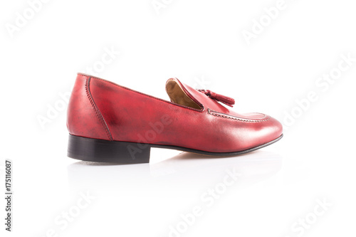 Close up of a red mens loafers on white background with reflection. Fashion advertising shoes photos.