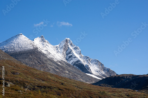 Snow-covered mountain peaks against clear blue sky
