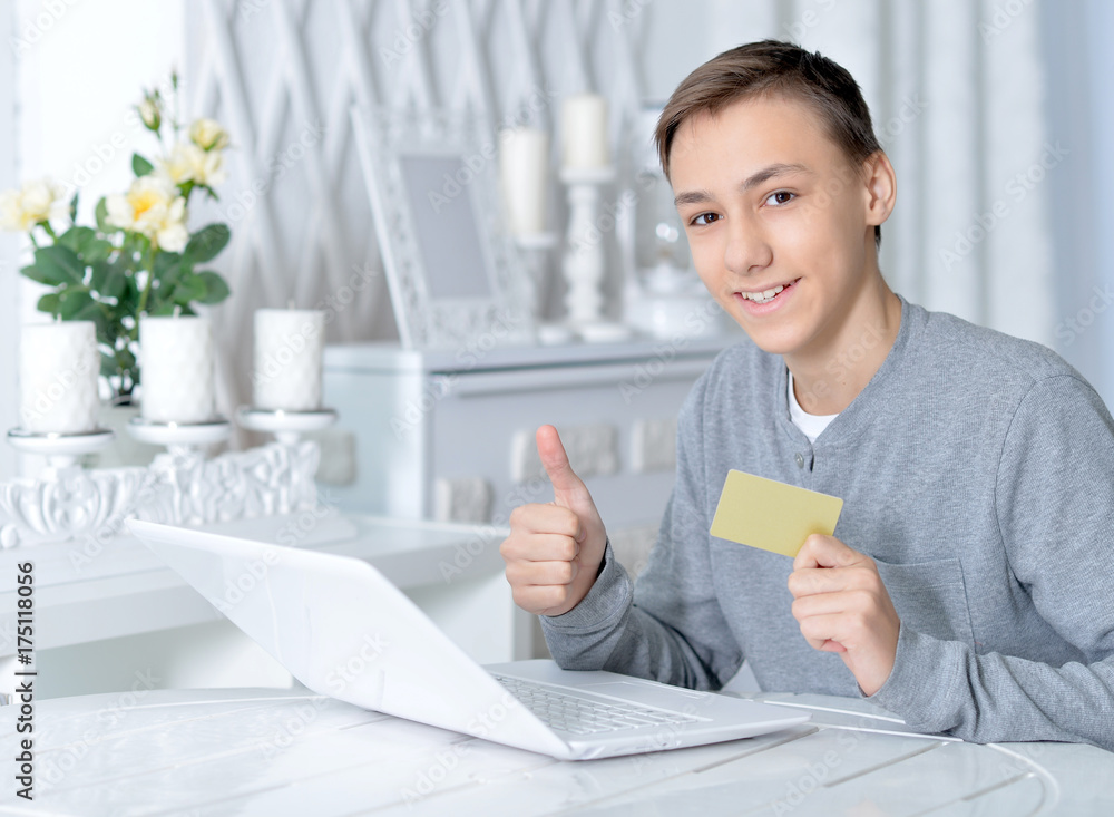 boy with laptop and credit card boy with laptop and credit card