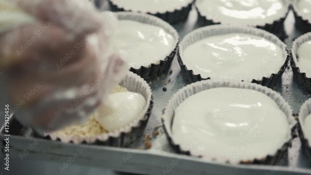 Female chef cook in rubber gloves preparing vanilla cake-mix dough in form for baking cake. Young woman baker pouring cream, bakery products Female chef cook in rubber gloves preparing vanilla cake-mix dough in form for baking cake. Young woman baker pouring cream, bakery products