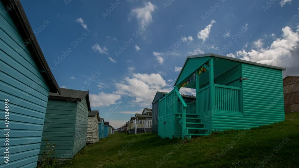 Time lapse of traditional english beach huts in whistable, kent, england on a summer's day Time lapse of traditional english beach huts in whistable, kent, england on a summer's day