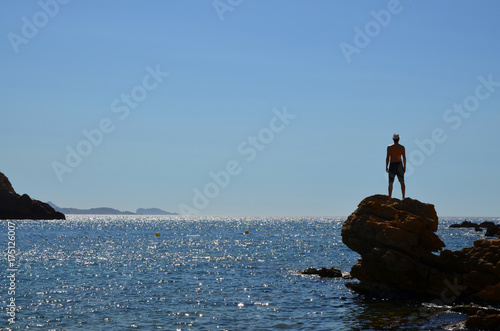 Man standing on rocks in the Calanques, Marseille