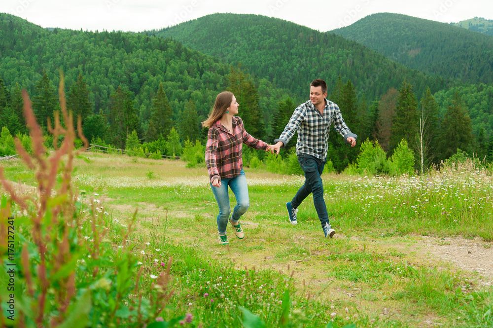 Young couple in love walking in mountains.