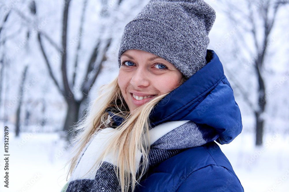 Beautiful winter portrait of young woman in the winter snowy scenery. Beautiful girl in winter clothes. Young woman portrait. beauty girl on the blurred background Beautiful winter portrait of young woman in the winter snowy scenery. Beautiful girl in winter clothes. Young woman portrait. beauty girl on the blurred background
