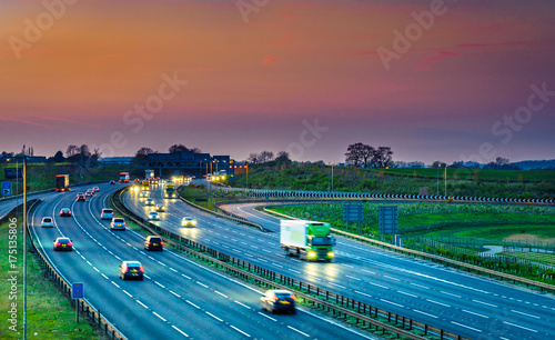 Colourful sunset at M1 motorway near Flitwick junction with blurry cars in United Kingdom photo