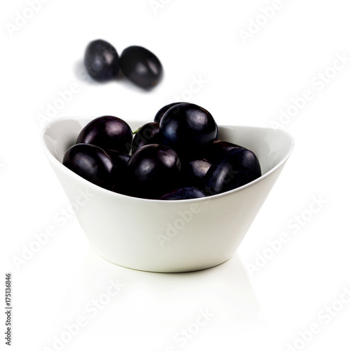 tasty plums in ceramic bowl