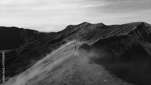 A man going in a fog along the cratrer of volcano Bromo