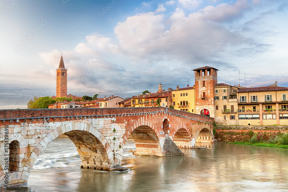 Famous Verona landmark. Ponte di Pietra over Adige river during sunrise.