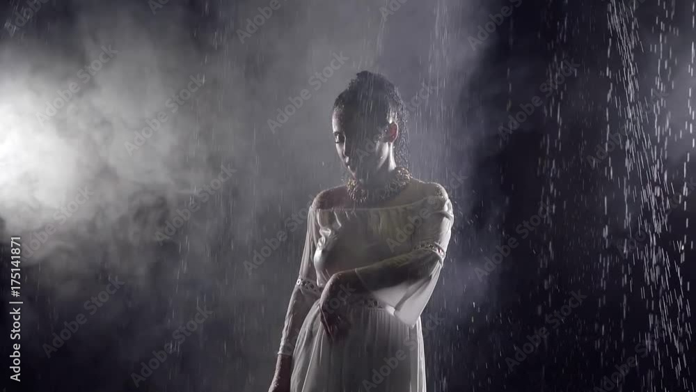 The woman is dripping water, the lady touches wet clothes with her hand The woman is dripping water, the lady touches wet clothes with her hand