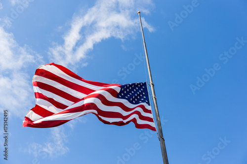 United States flag flying at a half-staff photo