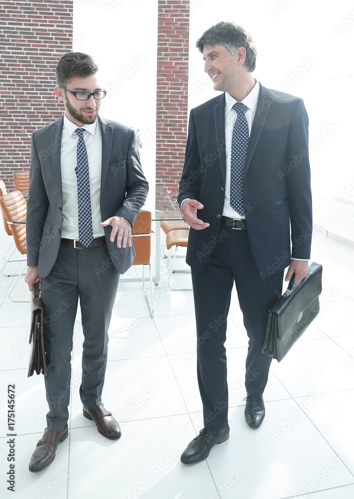 Two company employees discuss business issues Two company employees discuss business issues