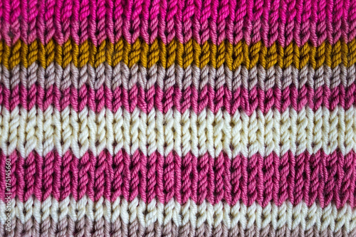 Knitted background of colored stripes.