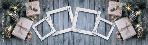 Christmas background with gift box and frames on wooden planks