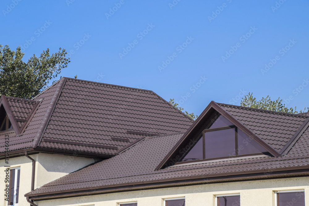 House with plastic windows and a brown roof of corrugated sheet