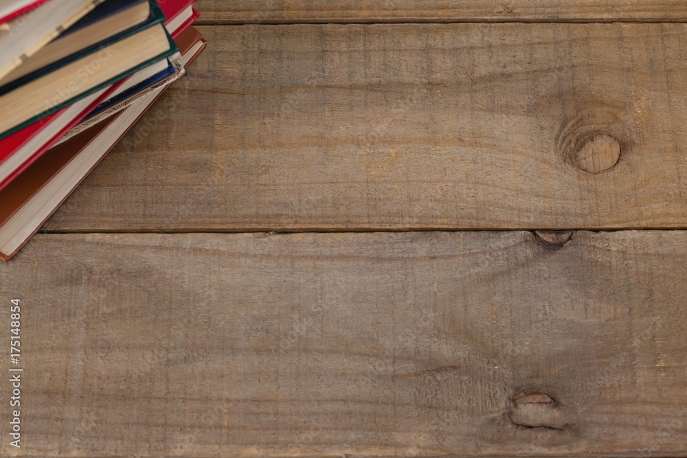 Fototapeta premium Stack of books on wooden background