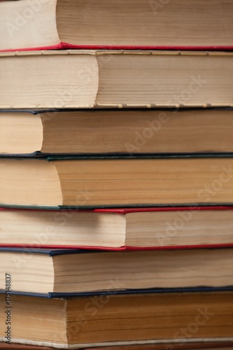 Stack of books against blue wooden background