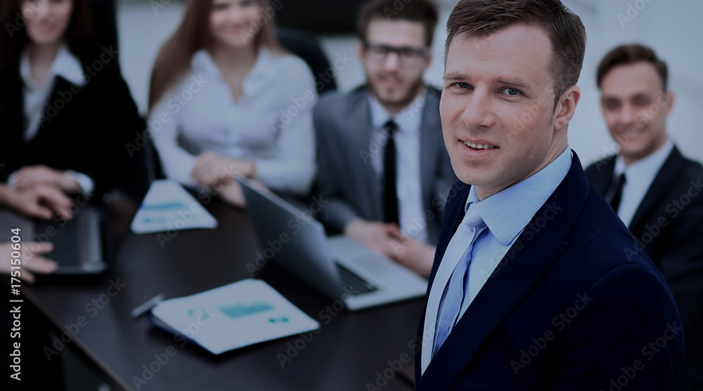 Portrait of an handsome businessman in front of his team Portrait of an handsome businessman in front of his team