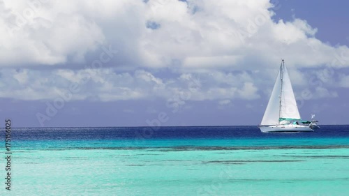 Sailboat sails off the coast of French Polynesia, wide