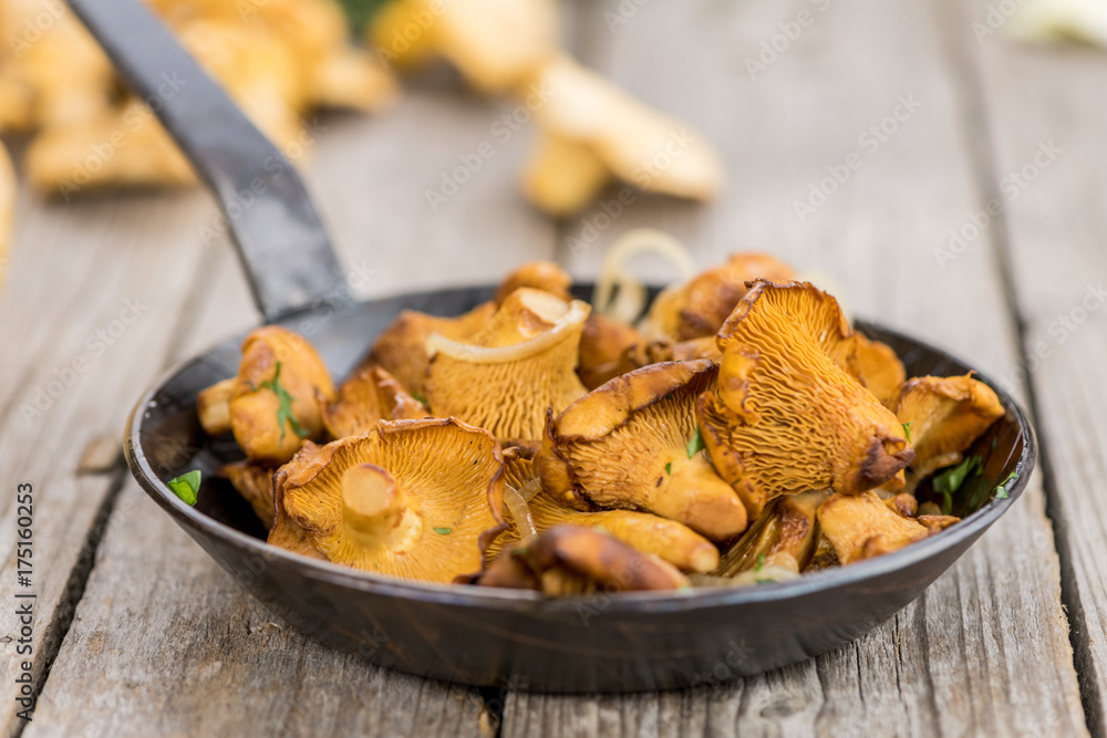 Fresh made Fried Chanterelles on a rustic background Fresh made Fried Chanterelles on a rustic background