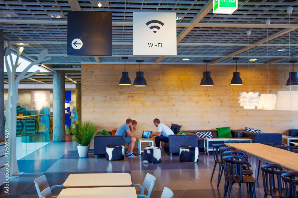 Wifi zone in modern cafe with blurred people on background. Wi-fi free at restaurant on blurred background.