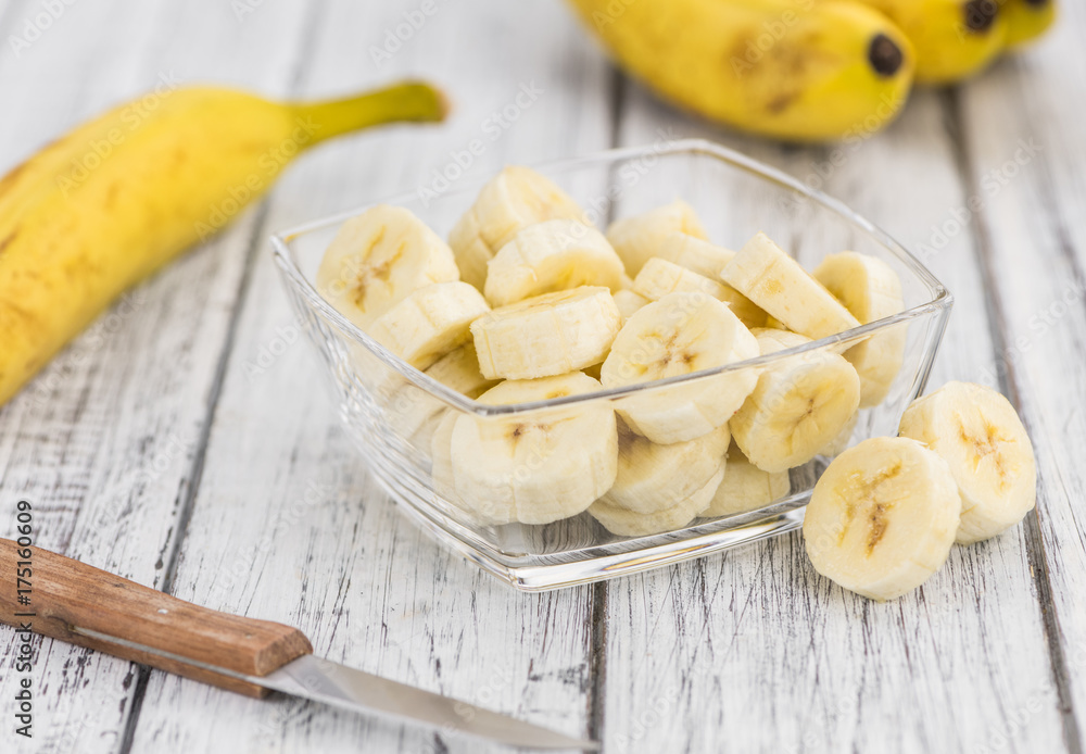 Portion of Sliced Bananas on wooden background, selective focus Portion of Sliced Bananas on wooden background, selective focus