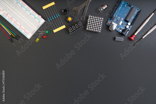 DIY electronic maker tools components on white background. DIY electronic maker tools with copy space for text on black background. DIY electronic handmade tools robot and electronic components. photo