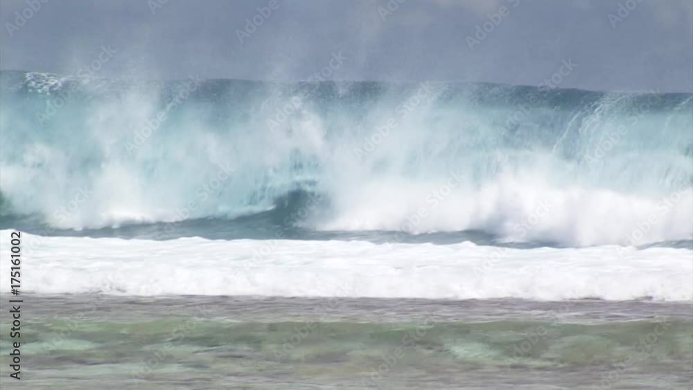 Enormous surfing wave crash on beach