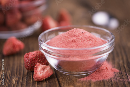 Strawberry powder on wooden background; selective focus