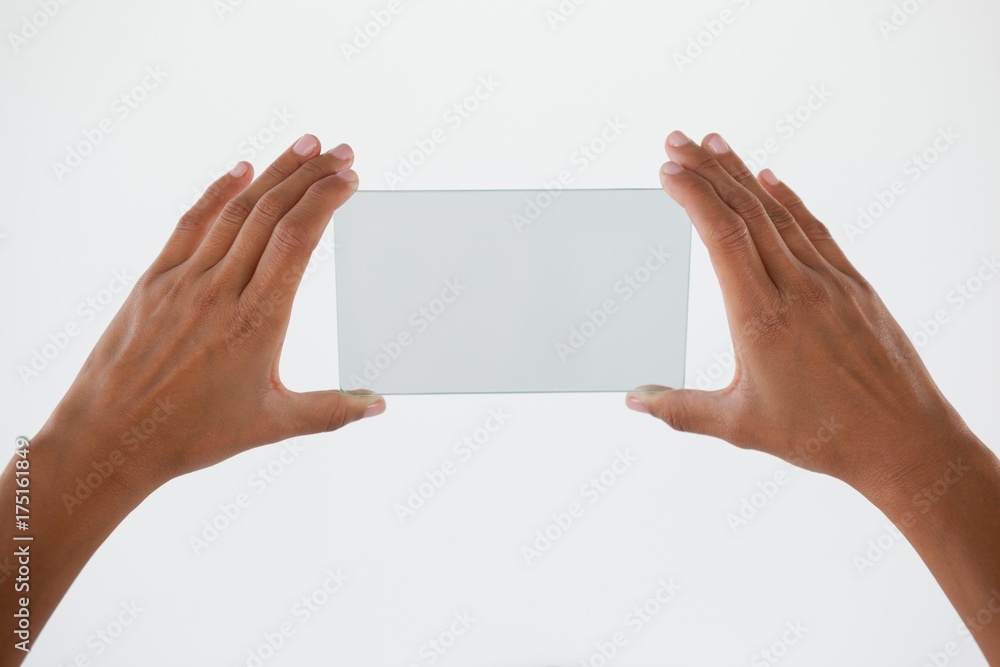 Hand holding a glass smartphone Hand holding a glass smartphone