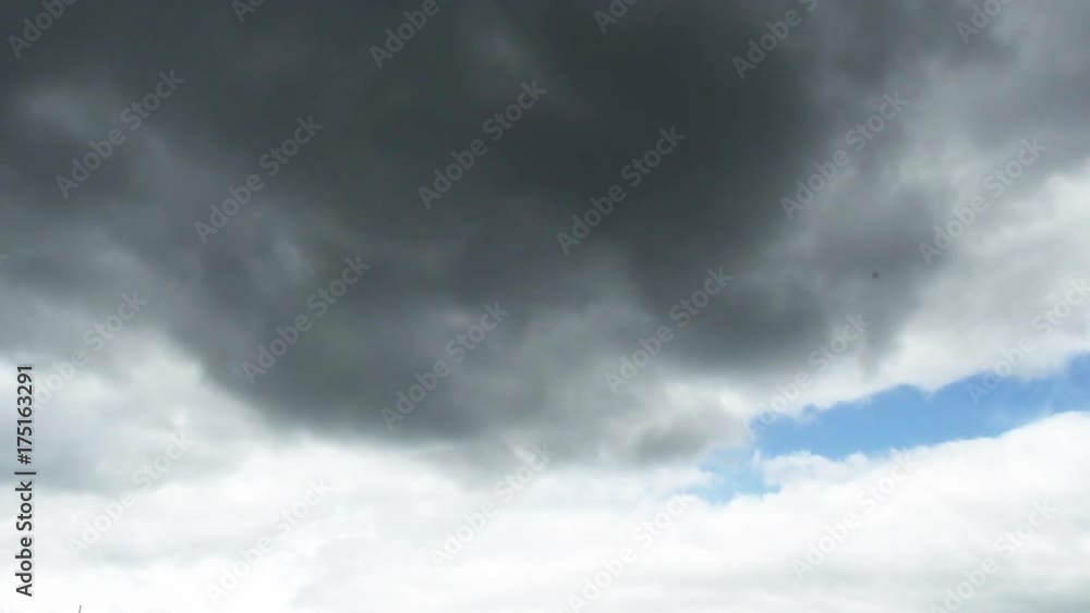 Time-lapse, grey clouds move across sky Time-lapse, grey clouds move across sky
