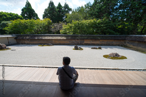 man sitting on a bench in park