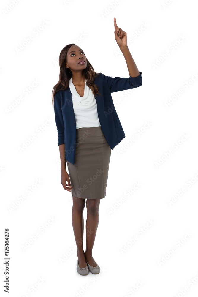 Fototapeta premium Full length of businesswoman pointing upwards