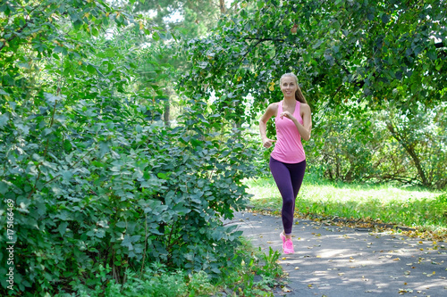 Portrait of a young woman running alone in the park