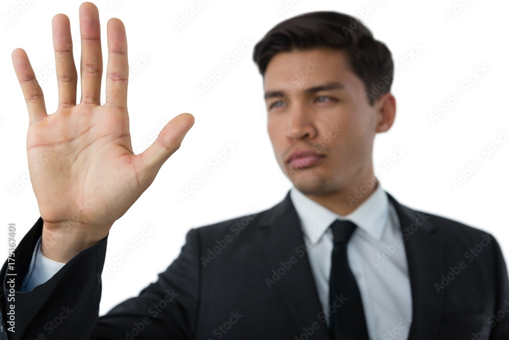 Close up of young businessman touching invisible interface Close up of young businessman touching invisible interface