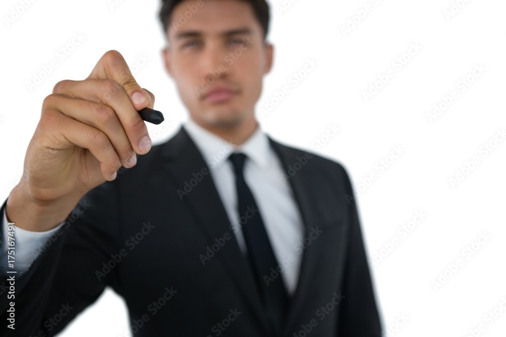 Businessman writing on invisible interface Businessman writing on invisible interface