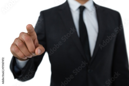 Mid section of businessman with pointing gesture