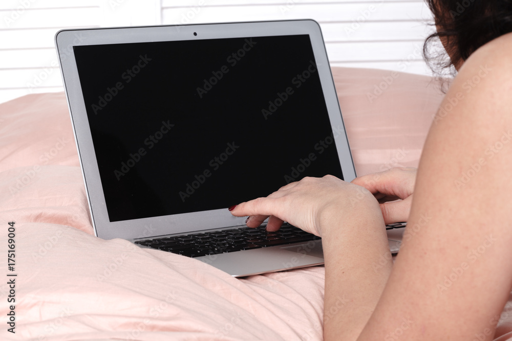 Beautiful lady busy early in the morning working from bed Beautiful lady busy early in the morning working from bed