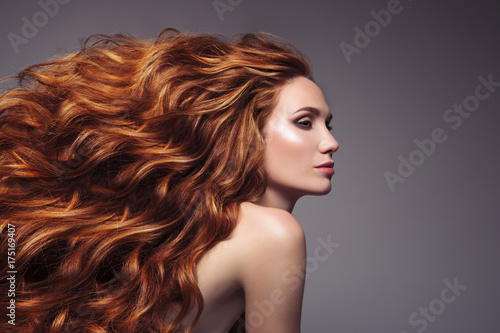 Portrait of woman with long curly beautiful ginger hair. photo