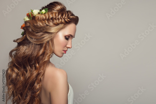 Close up portrait of young beautiful woman with flowers.