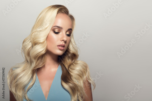 Blond woman with long curly beautiful hair.