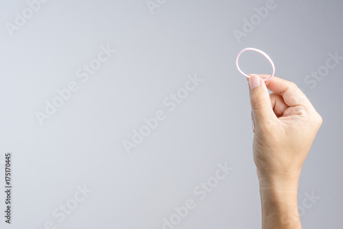 Hand holding pink elastic hair rubber band