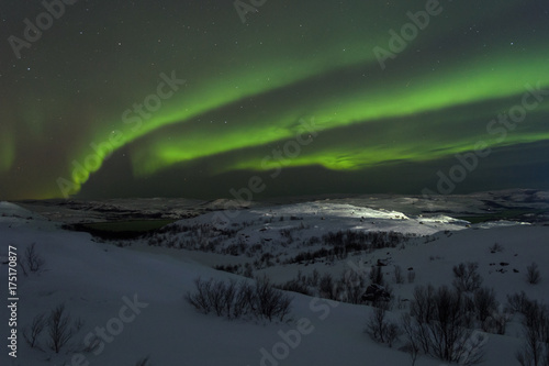 Tundra and hills covered with snow and polar lights. © Moroshka