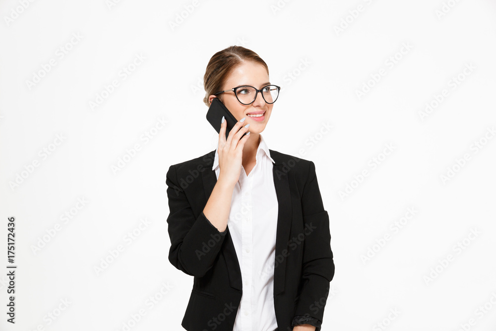Happy blonde business woman in eyeglasses talking by the smartphone Happy blonde business woman in eyeglasses talking by the smartphone