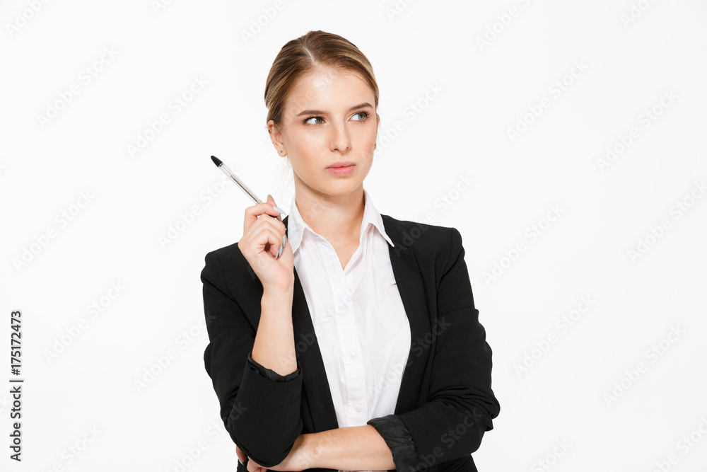 Serious blonde business woman holding pen and looking away Serious blonde business woman holding pen and looking away