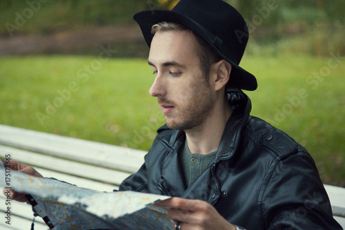 man with a map on a Park bench