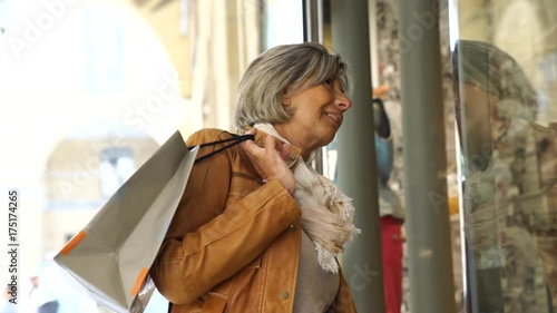 Senior woman on a shopping day looking at shop windows
