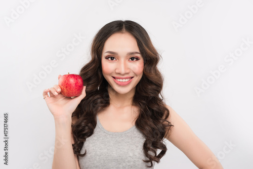 Happy sports woman showing red apple. Healthy fruit concept.